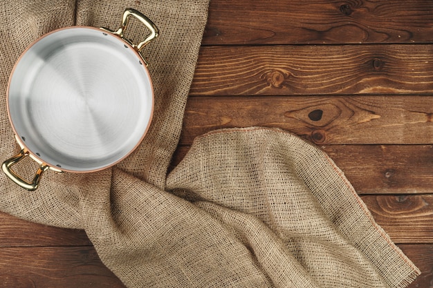 Pot de cuivre sur la table en bois sombre, vue de dessus