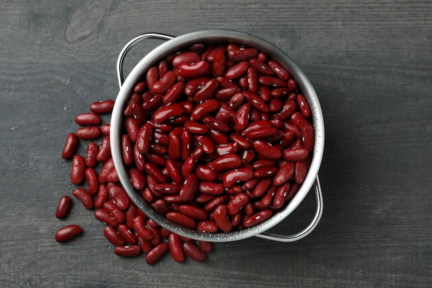 Pot avec des haricots rouges sur fond gris