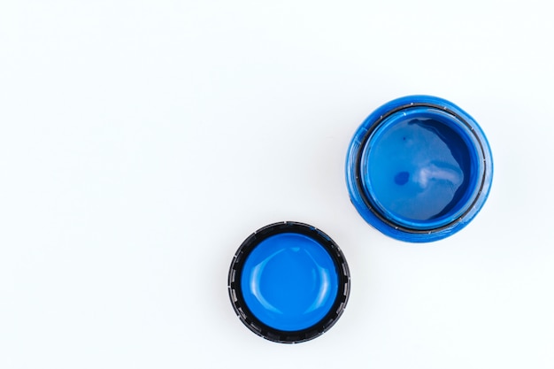 Pot de peinture acrylique bleue sur un espace de copie de fond blanc. peinture d'art.