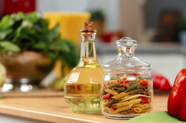 Pot en verre de pâtes sèches sur le comptoir de la cuisine