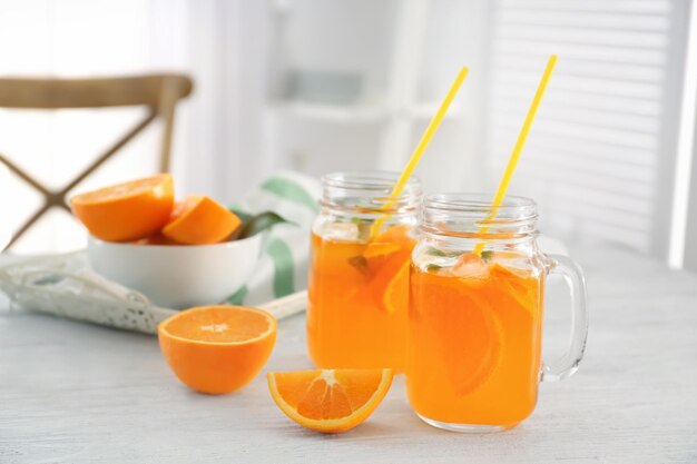 Pots Mason de limonade orange fraîche sur table