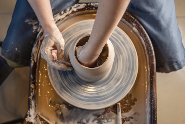 Potter travaillant sur une roue de potier faisant un vase