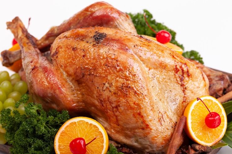 Photo poulet au four au citron et à la menthe sur fond blanc.