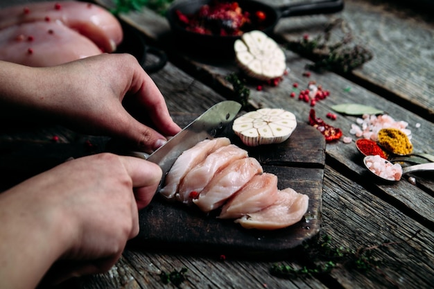 Poulet cru sur une table en bois avec des épices