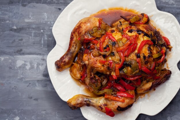 Poulet rôti aux herbes et légumes sur plat blanc