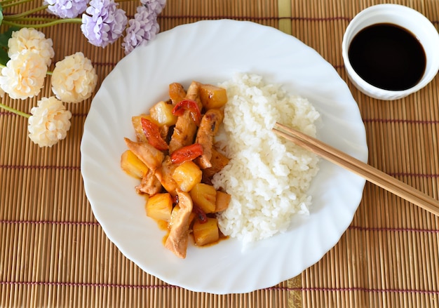 Poulet en sauce aigre-douce à l'ananas, paprika et riz