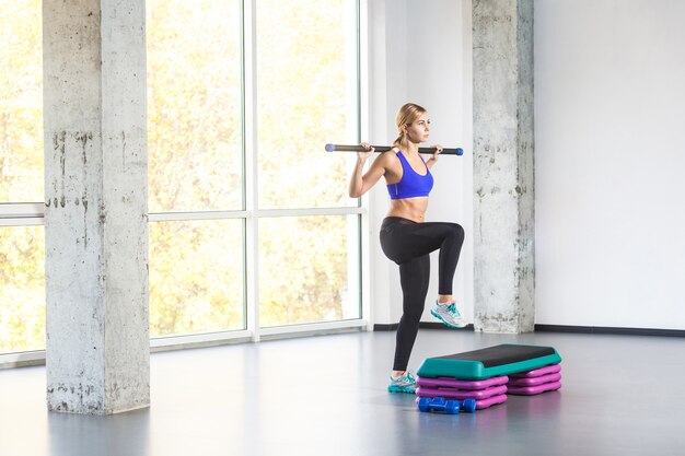 Pratique de femme sportive sur la plate-forme d'étape. Prise de vue en studio