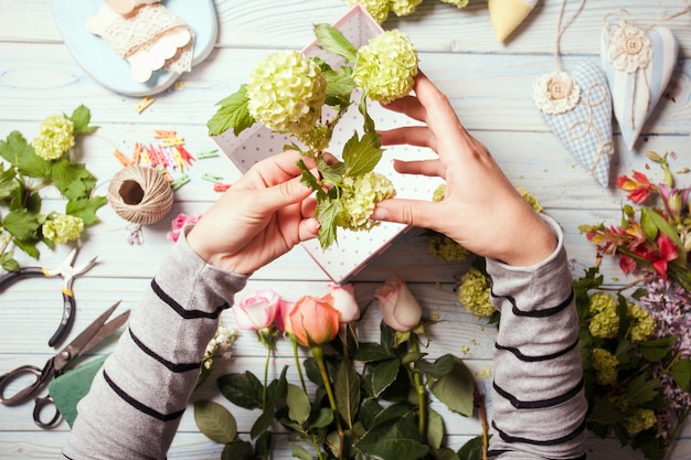 Préparation D'une Boîte à Fleurs Avec Des Macarons, Vue De Dessus Du Lieu De Travail Du Fleuriste