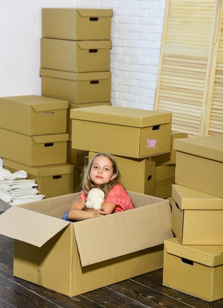 Près de partout où vous voulez être achat d'une nouvelle habitation petite fille heureuse avec jouet Concept de déménagement nouvel appartement enfant heureux boîte en carton Boîtes en carton déménageant dans une nouvelle maison
