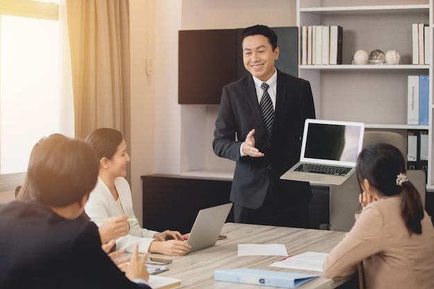 Présentation permanente de l'agent de vente adulte professionnel sur la salle de réunion spectacle ordinateur portable sourire heureux