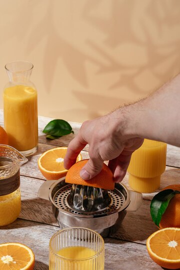 Presse-agrumes Pour Jus D'orange Fraîchement Pressé Sur Une Table En Bois  Dans Un Verre D'oranges