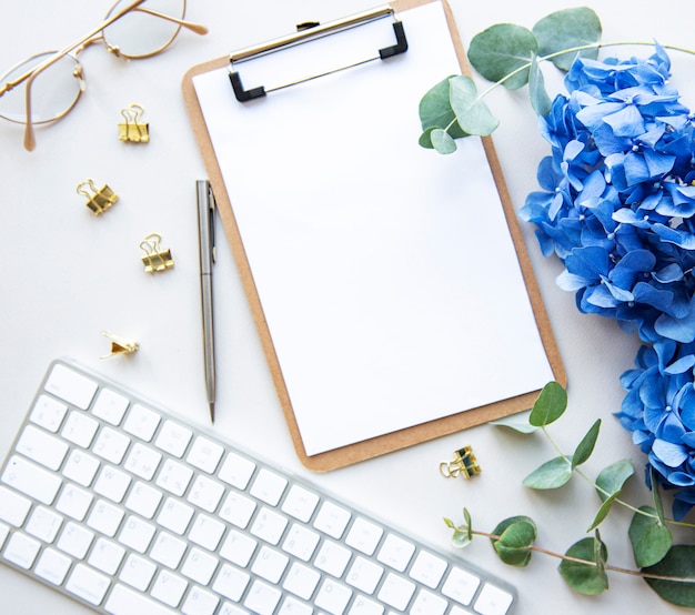 Presse-papiers vierge avec fleurs et clavier, vue de dessus