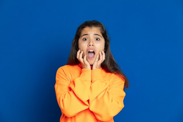 Preteen girl with yellow sweatshirt