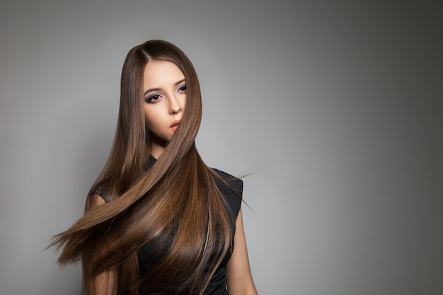 Prise de vue en studio d'un beau modèle sans émotion avec des cheveux volants en détournant les yeux