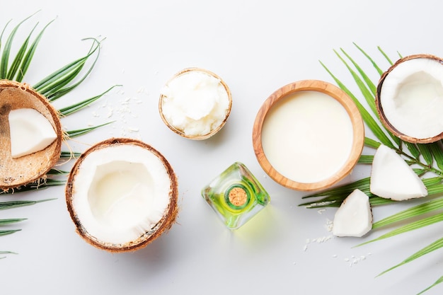 Produits de noix de coco huile de beurre mct copeaux d'huile de lait sur fond gris espace de copie concept de traitement de la peau et du corps des cheveux