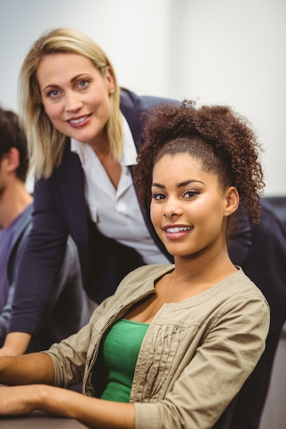 Professeur gai et étudiant regardant la caméra