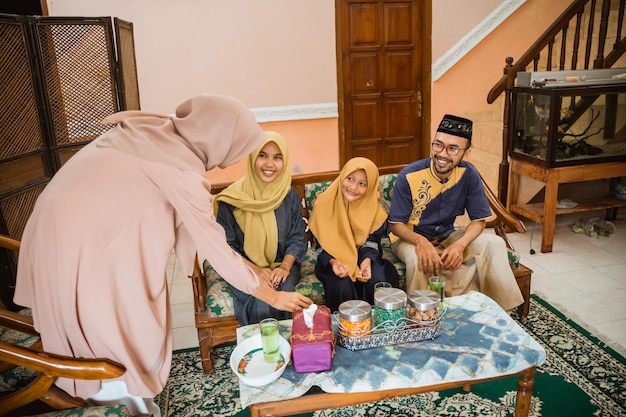 Propriétaire musulman servant ses invités avec un verre de boisson