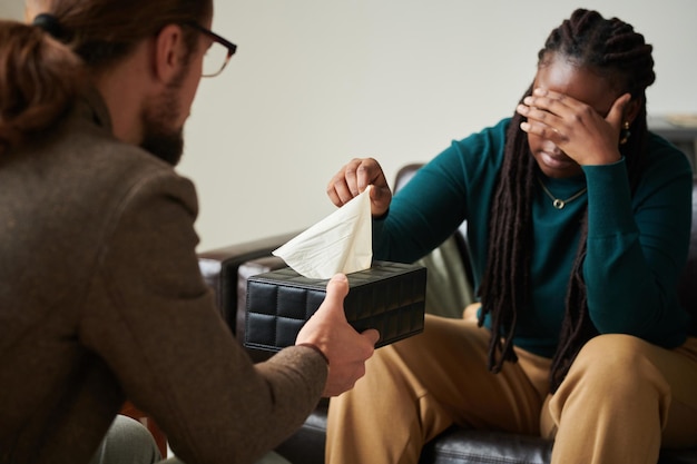 Psychiatre donnant des tissus à un patient déprimé