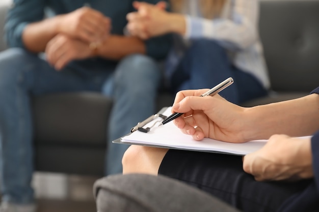 Psychologue travaillant avec jeune couple au bureau, gros plan