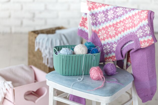 Pull bébé fille accroché au mur de mur de briques blanches