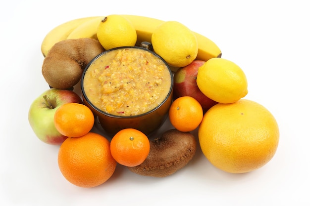 Purée dans une tasse de fruits frais hachés et de fruits entiers