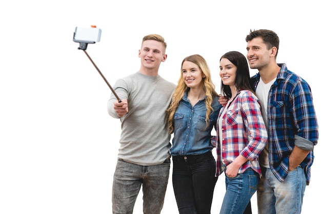 Les quatre amis font un selfie sur fond blanc