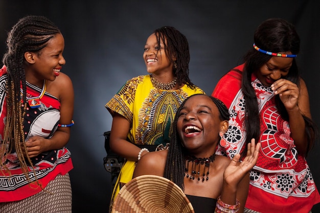 Quatre belles jeunes mannequins africaines s'amusent et rient en tenue traditionnelle !