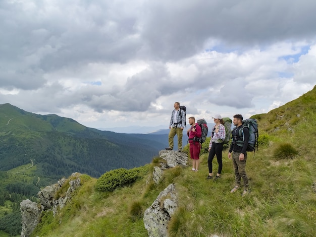 Les quatre personnes debout sur la montagne pittoresque