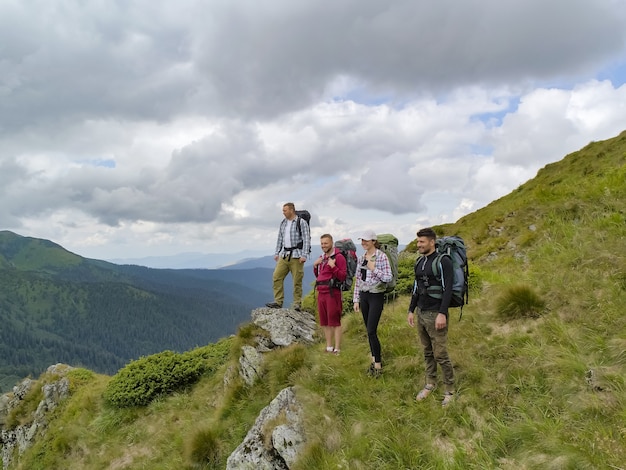 Les quatre personnes debout sur la montagne pittoresque