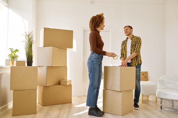 Quelques trucs d'emballage parmi de nombreuses boîtes en carton. Déménagement dans une nouvelle maison ou un appartement