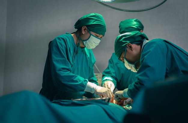 Équipe de chirurgien professionnel opérant un patient de chirurgie en salle d'opération à l'hôpital