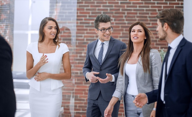 Équipe commerciale parlant debout dans le concept d'entreprise de corridor de bureau