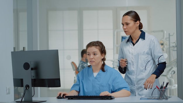 Équipe de dentisterie de spécialistes regardant l'écran d'ordinateur