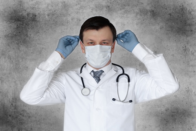 Équipement de prévention du personnel médical contre le coronavirus. Portrait d'homme médecin avec stéthoscope en masque.