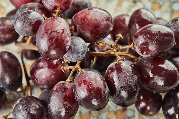 Raisins frais avec des gouttelettes d'eau sur la plaque, prêts à manger.