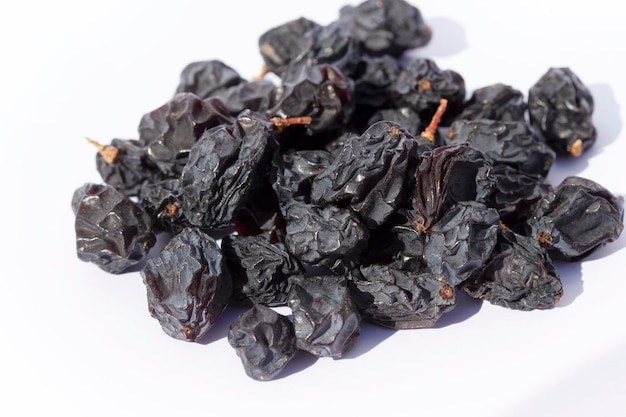 Raisins noirs biologiques isolés sur fond blanc