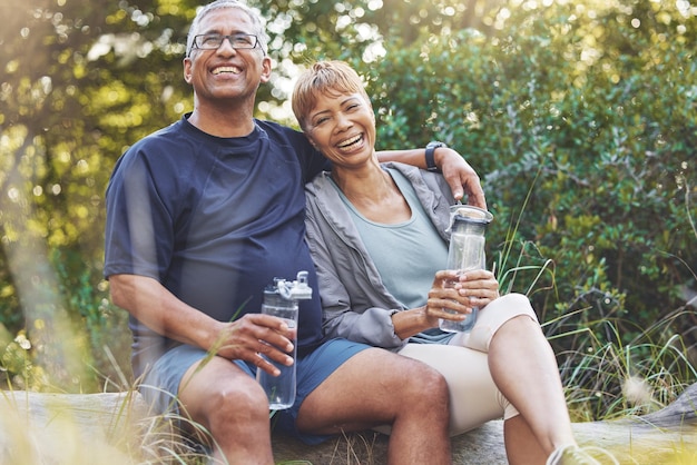 Randonnée dans la nature et portrait d'un couple de personnes âgées se reposant tout en faisant une promenade en plein air pour faire de l'exercice Sourire heureux et homme et femme âgés à la retraite en randonnée ensemble pour le bien-être dans une forêt au Brésil