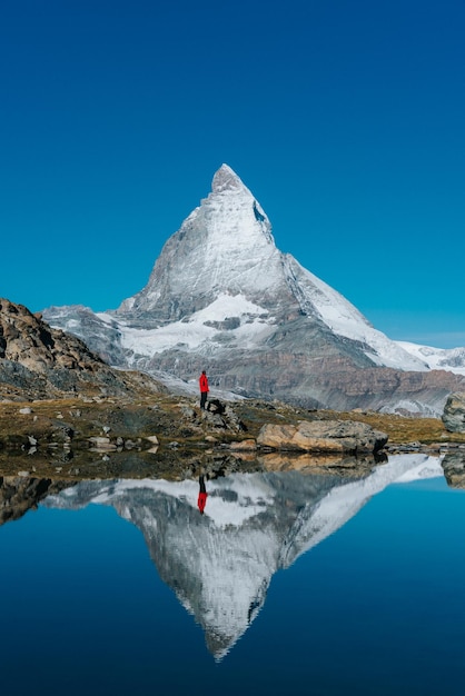 Un randonneur debout contre la montagne