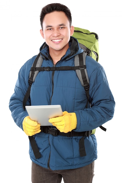 Randonneur masculin avec sac à dos à l'aide de la tablette tactile