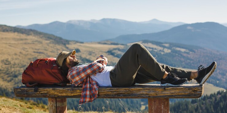 Photo randonneur masculin se reposant au sommet de la montagne