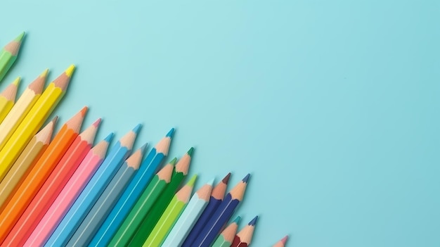 Une rangée de crayons de couleur sur fond bleu