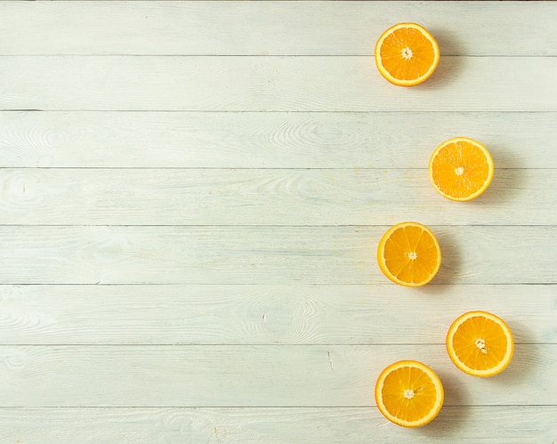 Rangée d'oranges fraîches, vue de dessus. Agrumes sains sur fond en bois blanc, vue de dessus, fond