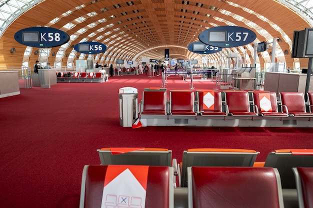 Des rangées de chaises vides dans un aéroport marqué pour la distanciation sociale. Aéroport parisien. photo de haute qualité