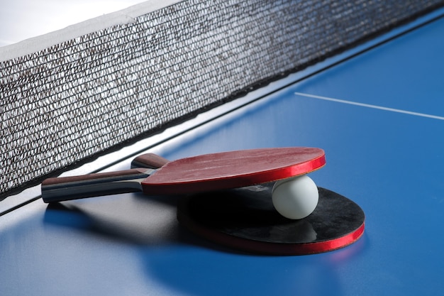 Raquettes de ping-pong avec une balle sur la table