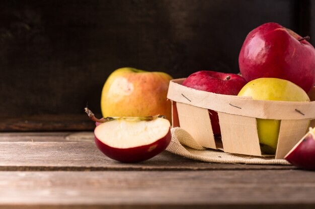 Récoltez les pommes. Pommes rouges sur une plaque en osier dans un style rustique. Pommes mûres d'automne.