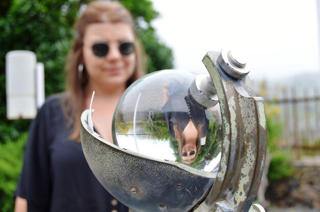Photo réflexion d'une femme debout à l'extérieur dans une boule de cristal