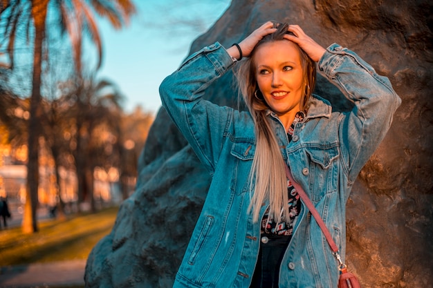 Regard d'une jeune blonde avec une veste regardant vers la gauche