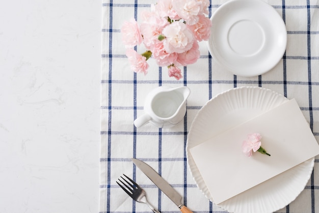 Réglage De La Table Avec Vaisselle, Couverts Et Fleurs Sur Fond Blanc