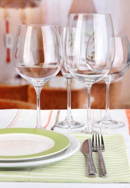 Réglage de la table avec des verres pour différentes boissons sur table sur fond de chambre