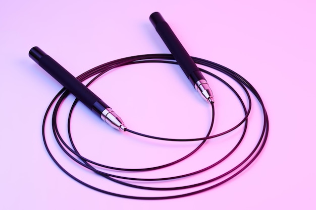 Photo remise en forme noire corde à sauter gros plan isolé sur fond rose équipement de sport